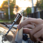 Man Hand Picking Up Car Windscreen Wiper.
Technician Changing Wi